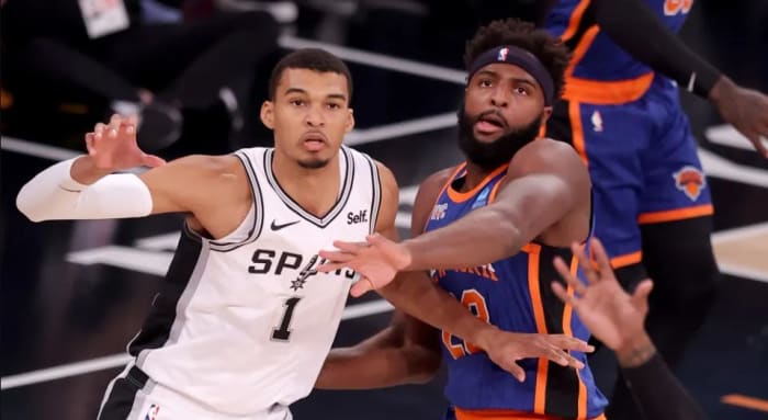 New York Knicks center Mitchell Robinson (23) defends San Antonio Spurs forward Victor Wembanyama (1) in the post